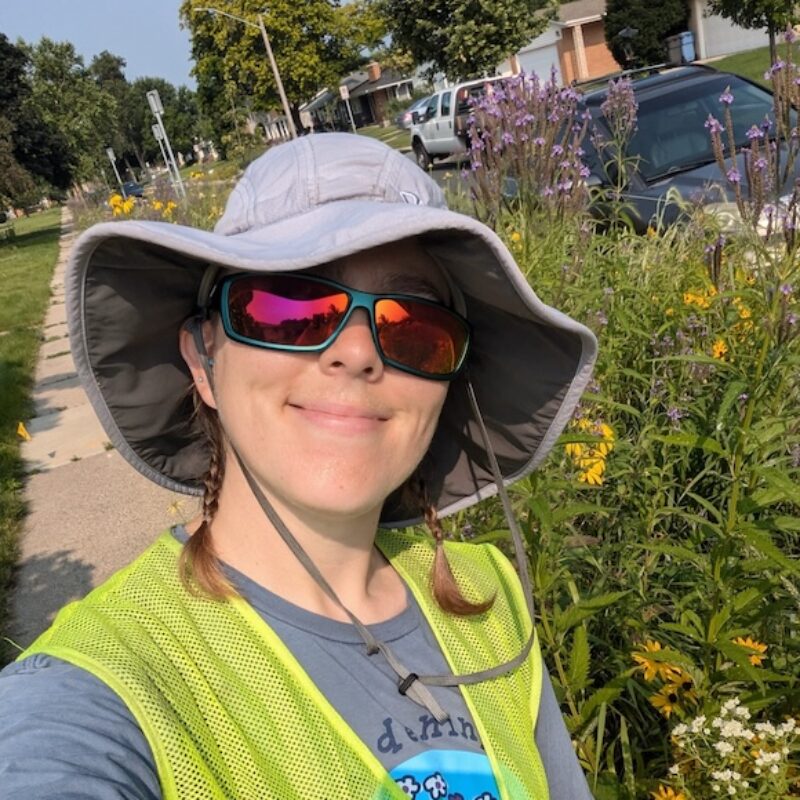 Woman with hat and sunglasses wearing yellow best