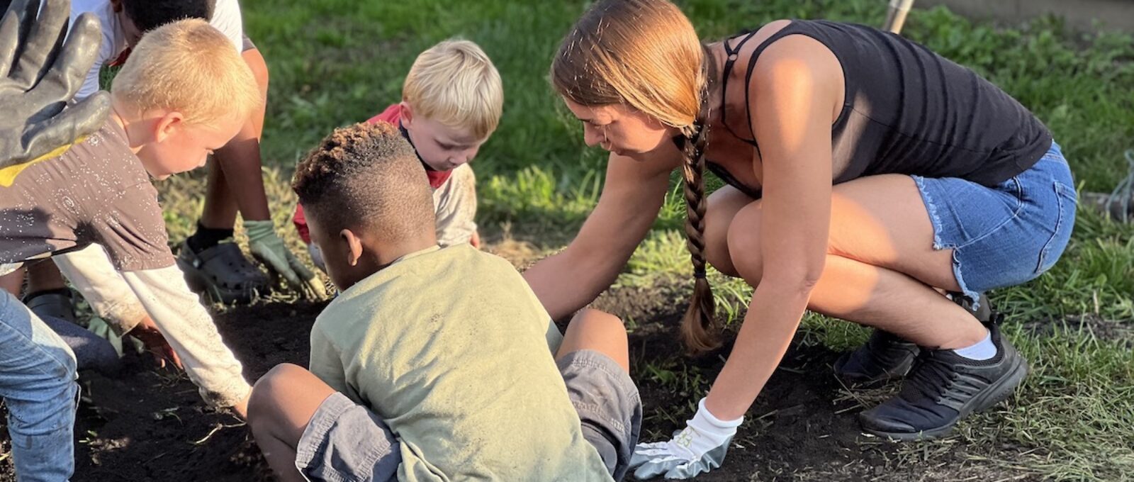 woman planting with kids
