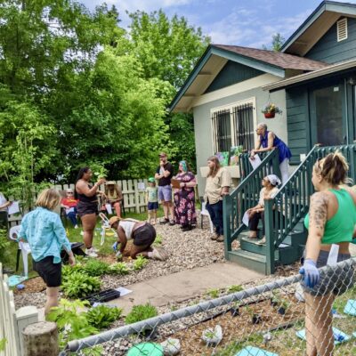 People in a front yard learning about gardening