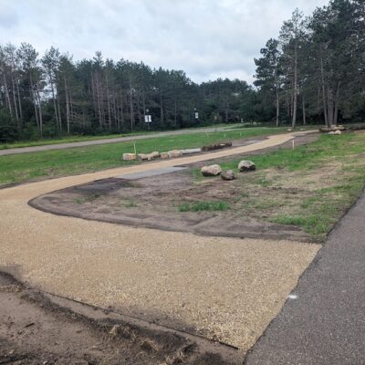 Walking path in Bunker Hills Regional Park by a site for a pollinator garden