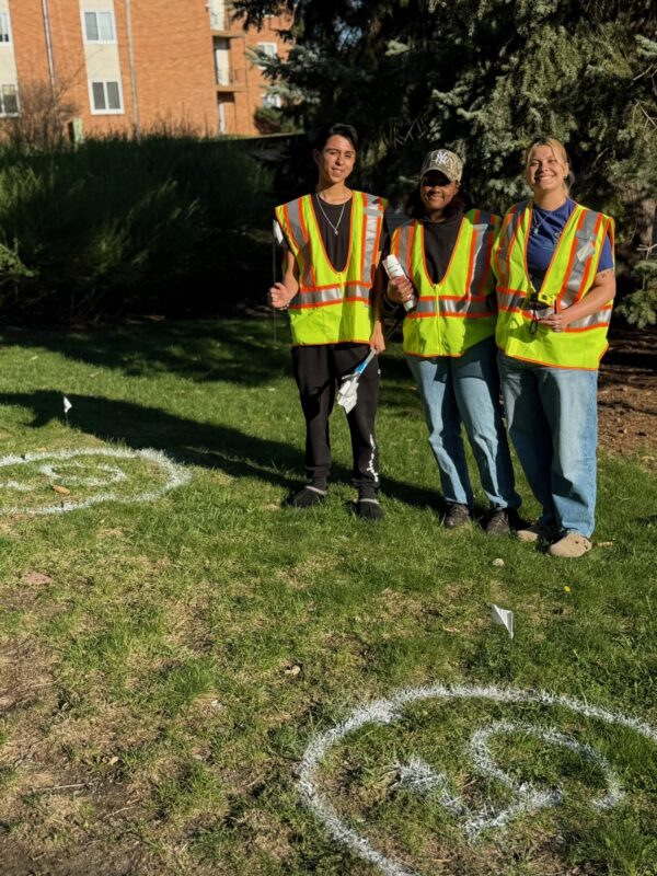 manny, laila, and makayla in high visibility vests marking the ground to plant trees